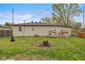 Spacious backyard with green grass, fire pit, and a small deck, great for outdoor entertaining at 409 W Pike St, Martinsville, IN 46151