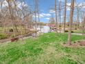 Picturesque backyard with lush lawn, lake access, and inviting fire pit area at 454 Roberson Blvd, Mooresville, IN 46158