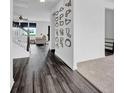 Stylish hallway features dark wood floors, white walls and trim, and an open staircase at 5374 Marigold Dr, Plainfield, IN 46168