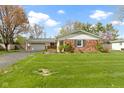 Quaint brick home with a green lawn and an attached two-car garage at 5420 E 81St St, Indianapolis, IN 46250