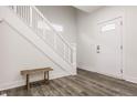 Bright entryway featuring hardwood floors, a staircase, and a white front door at 564 N Beville Ave, Indianapolis, IN 46201