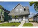 Charming renovated house with a gray exterior, inviting porch, and well-manicured lawn at 564 N Beville Ave, Indianapolis, IN 46201
