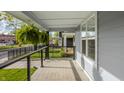 Inviting front porch with a hanging fern, offering a relaxing outdoor space with views of the neighborhood at 564 N Beville Ave, Indianapolis, IN 46201