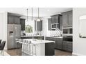 Modern kitchen with stainless steel appliances, gray cabinets, and a center island with seating at 5721 Palazzo Ln, McCordsville, IN 46055