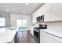 Modern kitchen featuring white cabinets, stainless steel appliances, and a large island at 5804 Summertree Pl, Whitestown, IN 46052