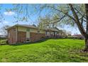 Side view of home with brick accents and a walkout basement on a lush green lawn at 7482 N Maple Dr, Frankton, IN 46044