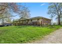 Single Gathering home with mature trees, brick accents and green lawn in a quiet neighborhood at 7482 N Maple Dr, Frankton, IN 46044