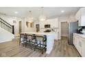 Bright kitchen features a large island with seating, stainless steel appliances, and modern pendant lighting at 827 Allandale Ave, Westfield, IN 46074