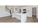 Modern kitchen featuring a central island with quartz countertops and stainless steel appliances at 827 Allandale Ave, Westfield, IN 46074