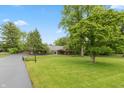 Sprawling brick home with lush greenery, manicured lawn and long drive at 8535 Washington Blvd, Indianapolis, IN 46240
