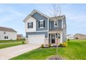 Beautiful two-story home featuring blue siding, white trim, a two-car garage, and a lush green lawn at 8694 Moyer Pl, Pendleton, IN 46064