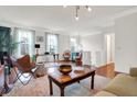 Bright living room featuring hardwood floors, neutral walls, stylish furniture and large windows at 967 Orlando St, Carmel, IN 46032