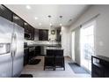 Open-concept kitchen featuring an island with seating and stainless steel appliances at 9770 Blue Violet Dr, Noblesville, IN 46060