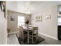 Inviting dining area with modern chandelier and decoratively adorned walls at 10597 Cyrus Dr, Indianapolis, IN 46231