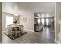 Open-concept dining room featuring modern light fixture and neutral tones at 10597 Cyrus Dr, Indianapolis, IN 46231