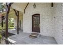 Beautiful front entry featuring covered porch with stone slate floor and timber pillars at 10628 Walnut Creek W Dr, Carmel, IN 46032