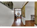 Inviting hallway featuring hardwood floors, natural light, and open dining space at 1111 Cambridge Dr, Greenwood, IN 46142