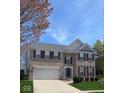Charming brick two-story home with a two car garage, manicured lawn, and dark shutters at 12561 Gladecrest Dr, Carmel, IN 46033