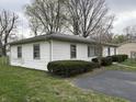 Classic white siding and neatly trimmed hedges surround this traditional home on a green lawn at 129 S Boehning St, Indianapolis, IN 46219