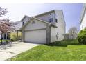 This two-story home boasts a spacious two-car garage and a well-manicured lawn, presenting a tidy exterior at 1328 Osprey Way, Greenwood, IN 46143