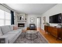 Bright living room with hardwood floors, stone fireplace, and neutral decor at 1355 E 56Th St, Indianapolis, IN 46220