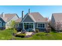 A spacious backyard features a stone patio with an outdoor dining set at 15150 Mooring E Cir, Carmel, IN 46033