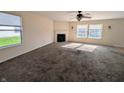 Spacious living room with neutral carpet, a fireplace, and bright windows at 18904 Planer Dr, Noblesville, IN 46062