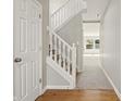 Bright and airy staircase with white railings and neutral carpet, leading to the upper level at 18904 Planer Dr, Noblesville, IN 46062