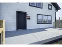 Charming home exterior featuring a black door, black trim, and a concrete porch at 2216 Bethel Ave, Indianapolis, IN 46203