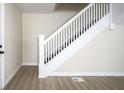 Bright staircase features white banisters and neutral walls that lead to upper level at 2216 Bethel Ave, Indianapolis, IN 46203