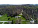 An aerial view of a charming home nestled within a lush, verdant landscape at 2455 Lenvoil Rd, Martinsville, IN 46151