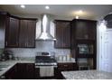 This kitchen features granite countertops, stainless steel appliances, modern cabinets and tiled backsplash at 2599 Liatris Dr, Plainfield, IN 46168