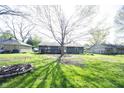 Spacious backyard featuring a large tree, deck and fire pit, perfect for outdoor entertaining and relaxation at 30 Sleepy Hollow Ct, Westfield, IN 46074
