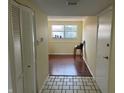 Bright entryway with tile floors leading into a room with wood floors and a window at 3010 Lake Shore Dr # D, Indianapolis, IN 46205