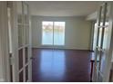 Spacious living room with hardwood floors and a large window view of the lake at 3010 Lake Shore Dr # D, Indianapolis, IN 46205
