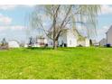 Picturesque backyard featuring a large tree offering shade and privacy, with recreational space at 3038 Arrowroot Ln, Indianapolis, IN 46239