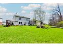 Spacious backyard with lush green grass, mature tree and recreational equipment for outdoor enjoyment at 3038 Arrowroot Ln, Indianapolis, IN 46239