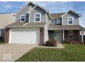 Inviting front porch with brick accents and a stylish, neutral colored front door at 3097 Limber Pine Dr, Whiteland, IN 46184