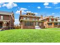 Beautiful brick home featuring a covered porch, well-manicured lawn, and mature trees at 3140 N Washington Blvd, Indianapolis, IN 46205