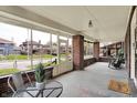Relaxing screened porch with brick accents, comfortable seating, and a view of the neighborhood at 3140 N Washington Blvd, Indianapolis, IN 46205