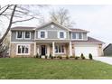 Charming two-story home with a manicured lawn, stone accents, and a welcoming front porch at 3316 Eden Way Cir, Carmel, IN 46033