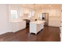 Bright, modern kitchen with white cabinets, stainless steel appliances, and a center island at 3316 Eden Way Cir, Carmel, IN 46033