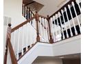 Elegant staircase featuring wood railings and white spindles at 3476 Golden Gate N Dr, Carmel, IN 46074