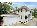 Home exterior with attached garage and well-maintained stucco siding at 3544 Guilford Ave, Indianapolis, IN 46205