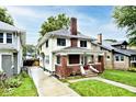 Charming two-story home with a brick chimney and inviting front porch at 3544 Guilford Ave, Indianapolis, IN 46205
