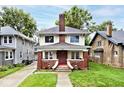Traditional two-story home with a brick chimney and covered front porch at 3544 Guilford Ave, Indianapolis, IN 46205