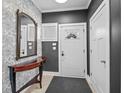 Welcoming foyer featuring stylish wallpaper, a decorative mirror, and sleek gray walls at 357 Parkway Ave, Indianapolis, IN 46225