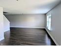 A spacious living room showcasing wood-look flooring and natural light at 3930 Towhees Dr, Indianapolis, IN 46237