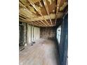 Spacious living room under renovation, revealing exposed beams and potential for customization at 4206 Clark St, Anderson, IN 46013
