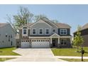 Charming two-story home with a three-car garage, stone accents, and well-manicured front lawn at 4333 Ironclad Dr, Bargersville, IN 46106